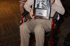 Tim Coakley, longtime Capital Region jazz historian, poses with a plaque commerating his contributions to the local jazz community during Jazz on Jay in Robb Alley at Proctors in Schenectady on June 26, 2025. Photo by Kevin Montano for Proctors Collaborative.