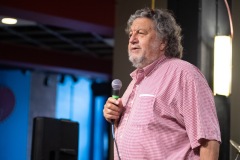 Philip Morris, CEO of Proctors Collaborative, speaks before presenting a plaque recognizing longtime Capital Region jazz historian Tim Coakley during Jazz on Jay in Robb Alley at Proctors in Schenectady on June 26, 2025. Photo by Kevin Montano for Proctors Collaborative.