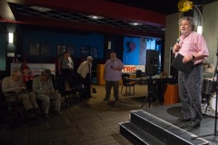Philip Morris, CEO of Proctors Collaborative, speaks before presenting a plaque recognizing longtime Capital Region jazz historian Tim Coakley (far left) during Jazz on Jay in Robb Alley at Proctors in Schenectady on June 26, 2025. Photo by Kevin Montano for Proctors Collaborative.